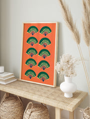 Pattern of stylised green and yellow Japanese fans on a vibrant orange background, in an alternate framed mockup