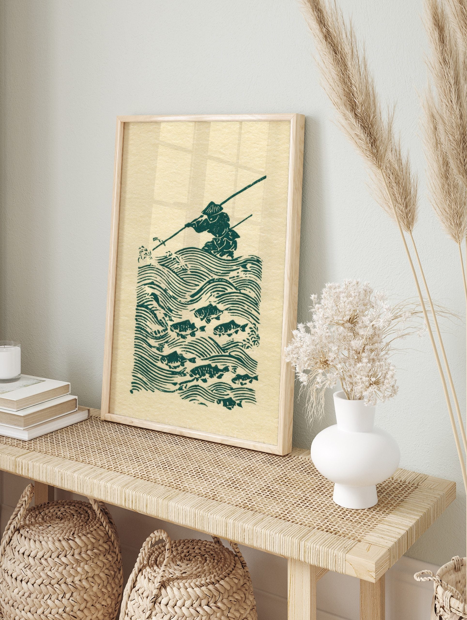 Green woodblock print of a Japanese fisherman in a conical hat, spearing fish in stylised, in an alternate framed mockup