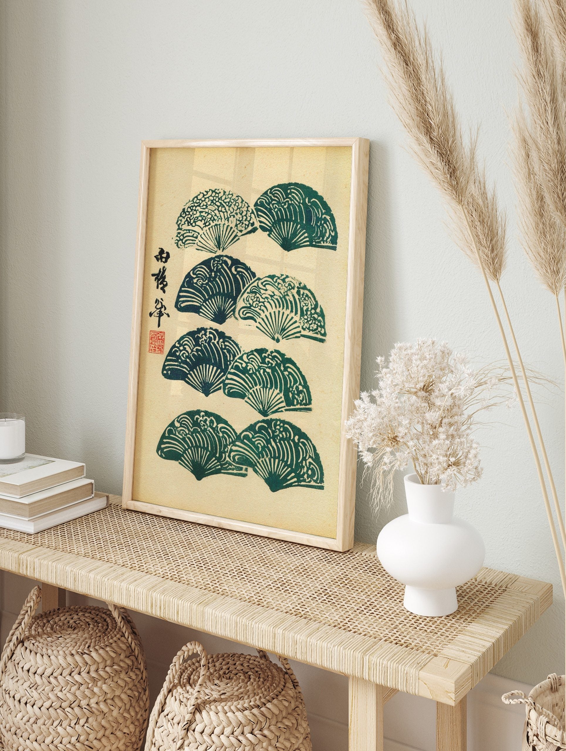 Japanese folding fans with wave patterns and calligraphy in green and beige, woodblock print, in an alternate framed mockup