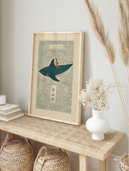 Japanese folk art print of a woman riding a spotted whale shark on wavy teal water with Kanji, in an alternate framed mockup