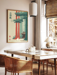 Illustrative Japanese forest shrine wall art with white cat, tall red and green trees, and, in a styled room mockup