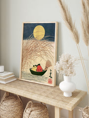 Japanese woodblock-style print of a yellow frog and red fish in a boat under a full moon with, in an alternate framed mockup