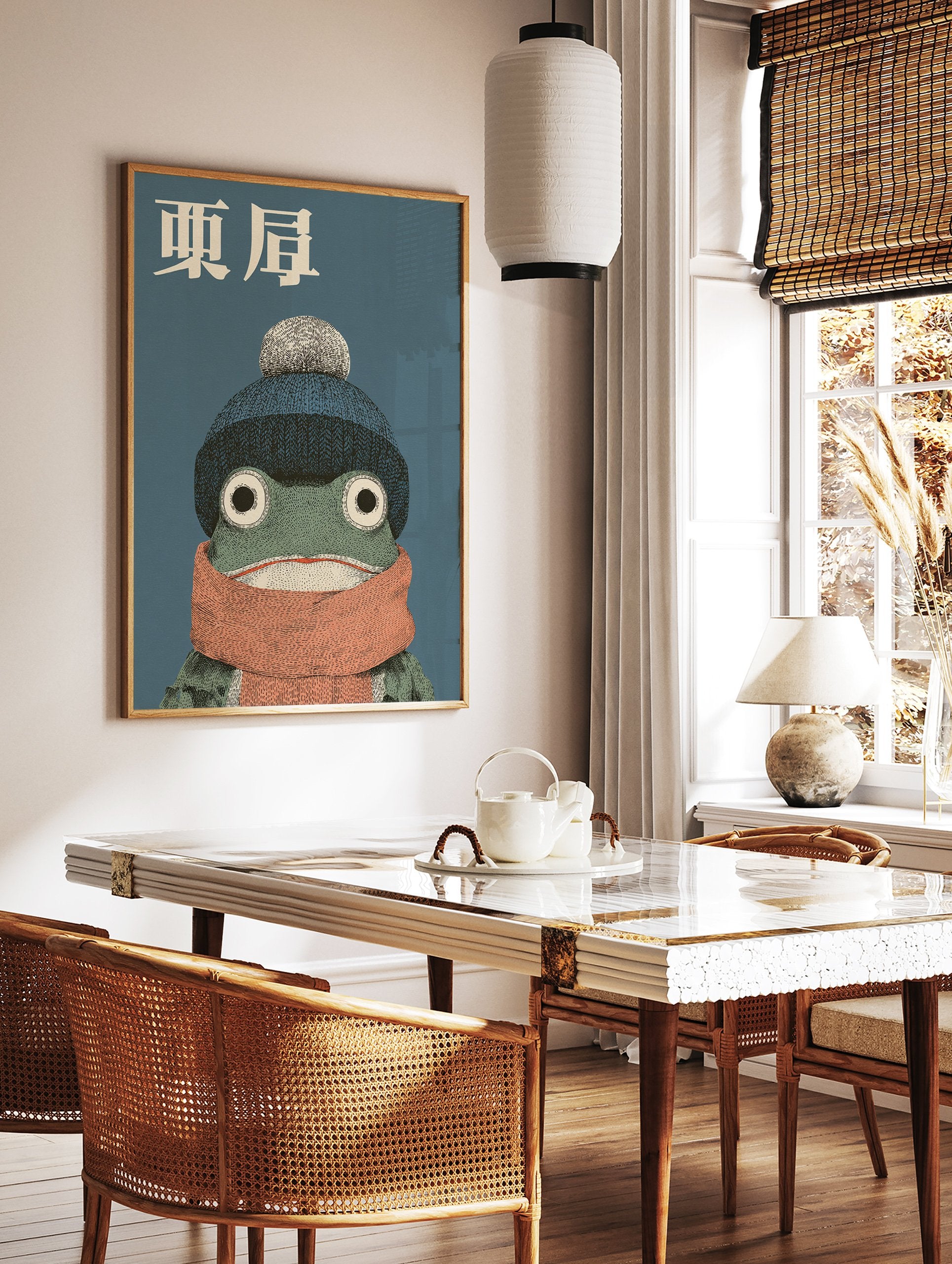 Japanese frog art print featuring a green frog wearing a blue knit hat with a pompom and an orange scarf on a blue background. - Image 2