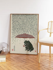 Japanese style illustration of a green frog holding a red umbrella in the rain on a textured beige background. - Image 2