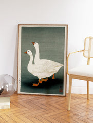 Japanese woodblock print of two white geese with orange beaks and feet on a muted greenish-grey background. - Image 2