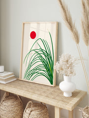 Minimalist Japanese style art print with green grass stalks and a red sun on a cream, in an alternate framed mockup