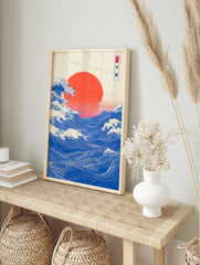 Japanese Great Wave art print with blue ocean waves, white foam, and a large red sun, in an alternate framed mockup