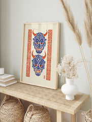 Japanese Hannya mask illustration with blue demon faces, red horns and red kanji borders on, in an alternate framed mockup