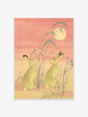 Japanese Hare Art print featuring two hares, moon, and reeds in traditional Ukiyo-e style with pink and green tones.