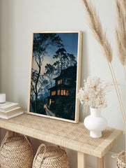 Japanese house art print at twilight with glowing windows, silhouetted pine trees, and a, in an alternate framed mockup