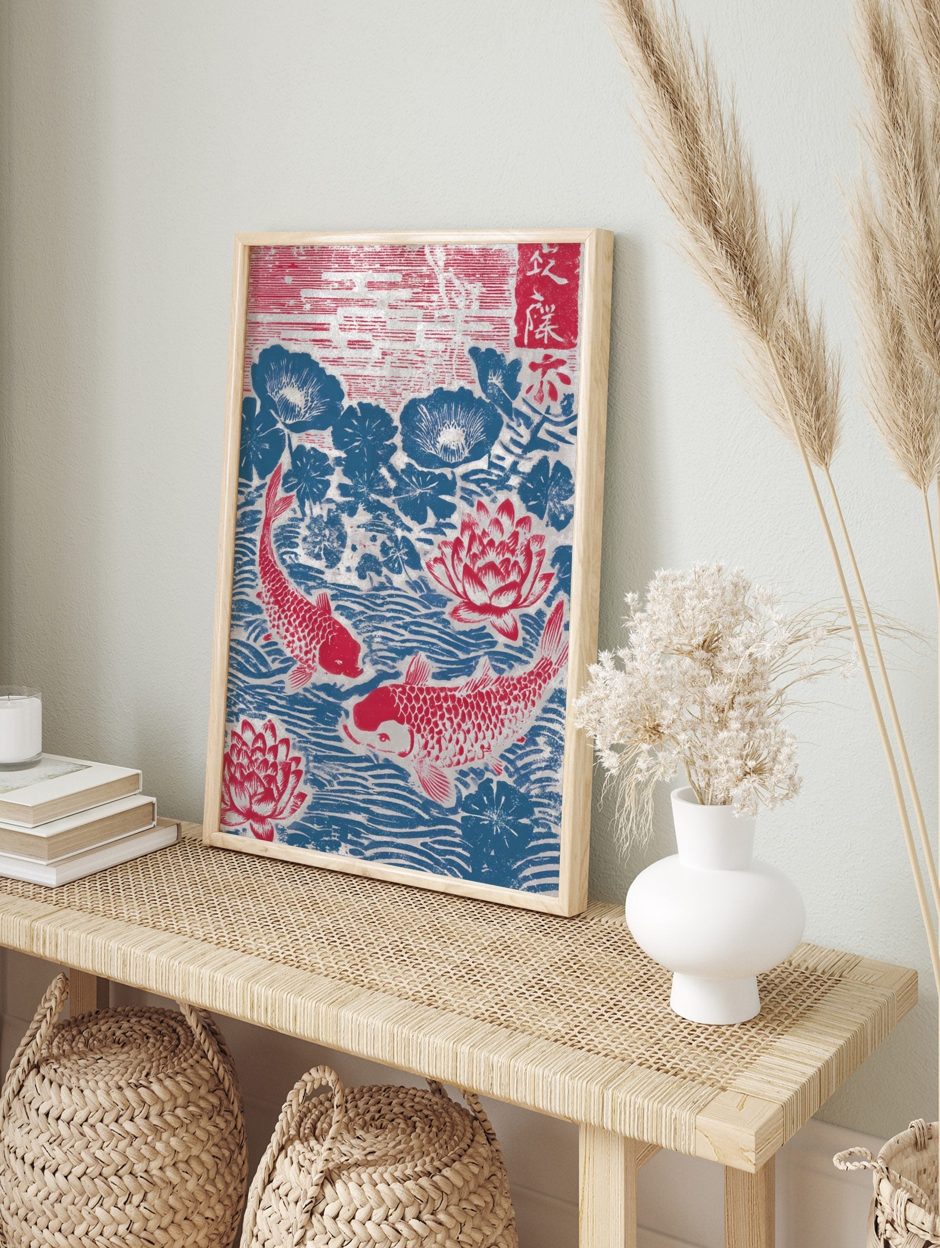 Japanese woodblock print of two red koi fish swimming among red lotus flowers and blue lily, in an alternate framed mockup