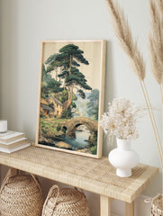Traditional Japanese landscape art print showing a village with houses, pine trees, stone bridge over a river, and mountains. - Image 3