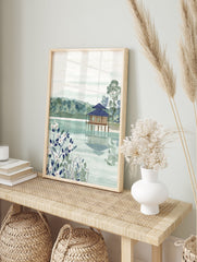 Japanese landscape wall art featuring a serene lakeside house, lush trees, and white botanical flowers in the foreground. - Image 3