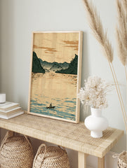 Illustrative Japanese-style landscape print showing a lone boatman on calm water with misty, in an alternate framed mockup