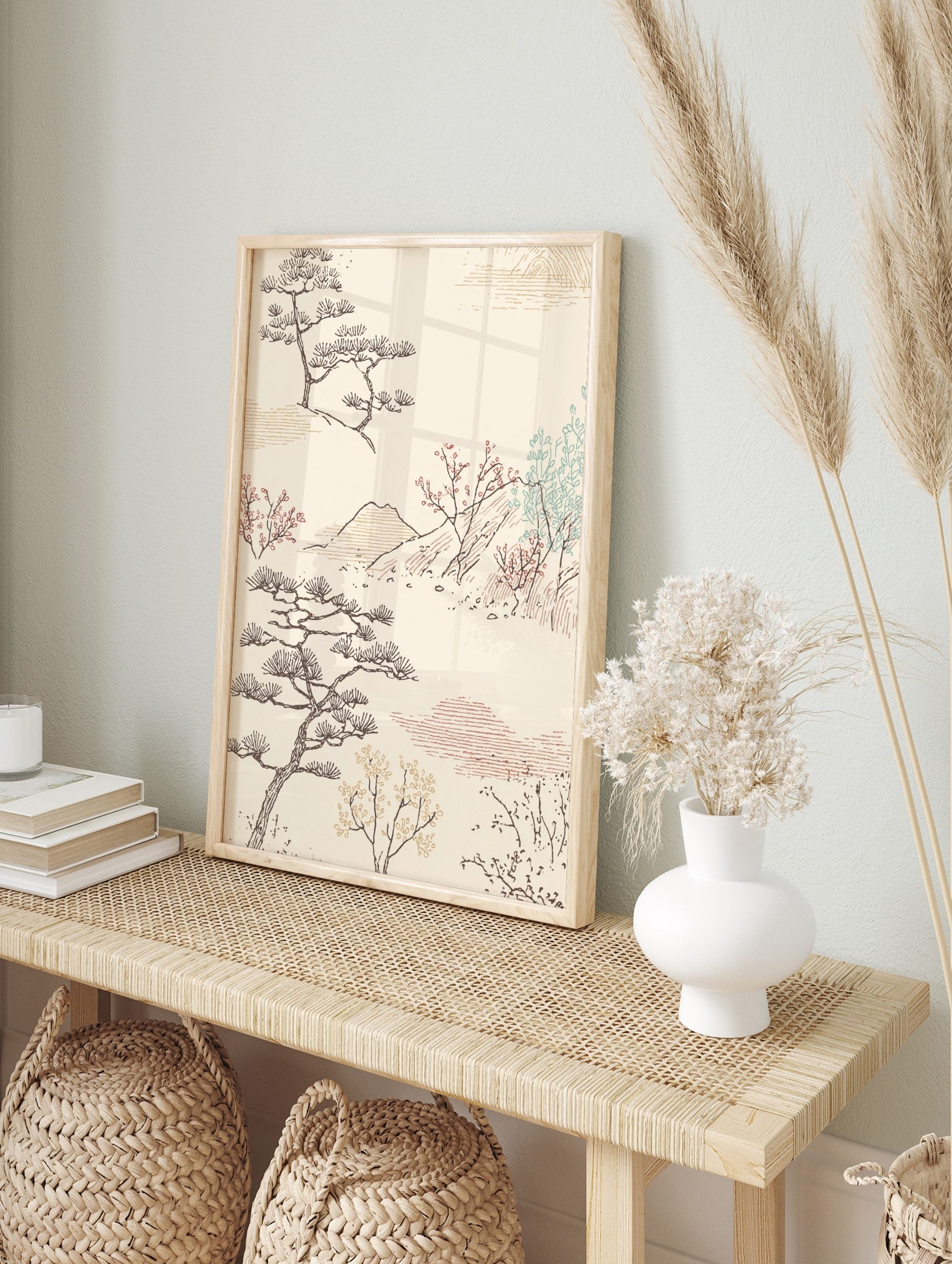 Japanese landscape art print with stylised pine trees, red blossom branches, mountains, and, in an alternate framed mockup