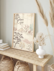 Japanese landscape art print with stylised pine trees, red blossom branches, mountains, and, in an alternate framed mockup