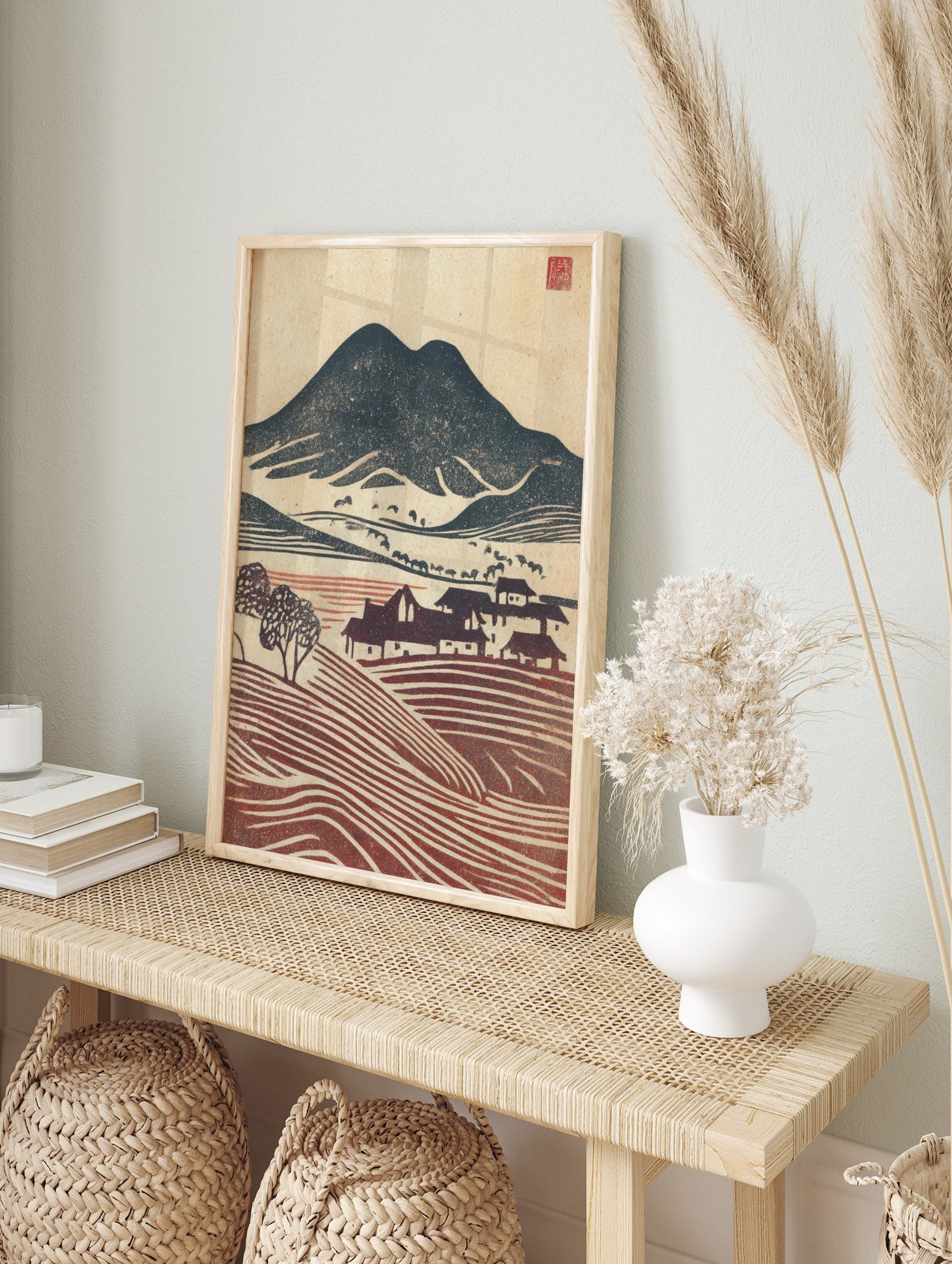 Japanese woodblock style landscape print with dark mountain, village houses, and, in an alternate framed mockup