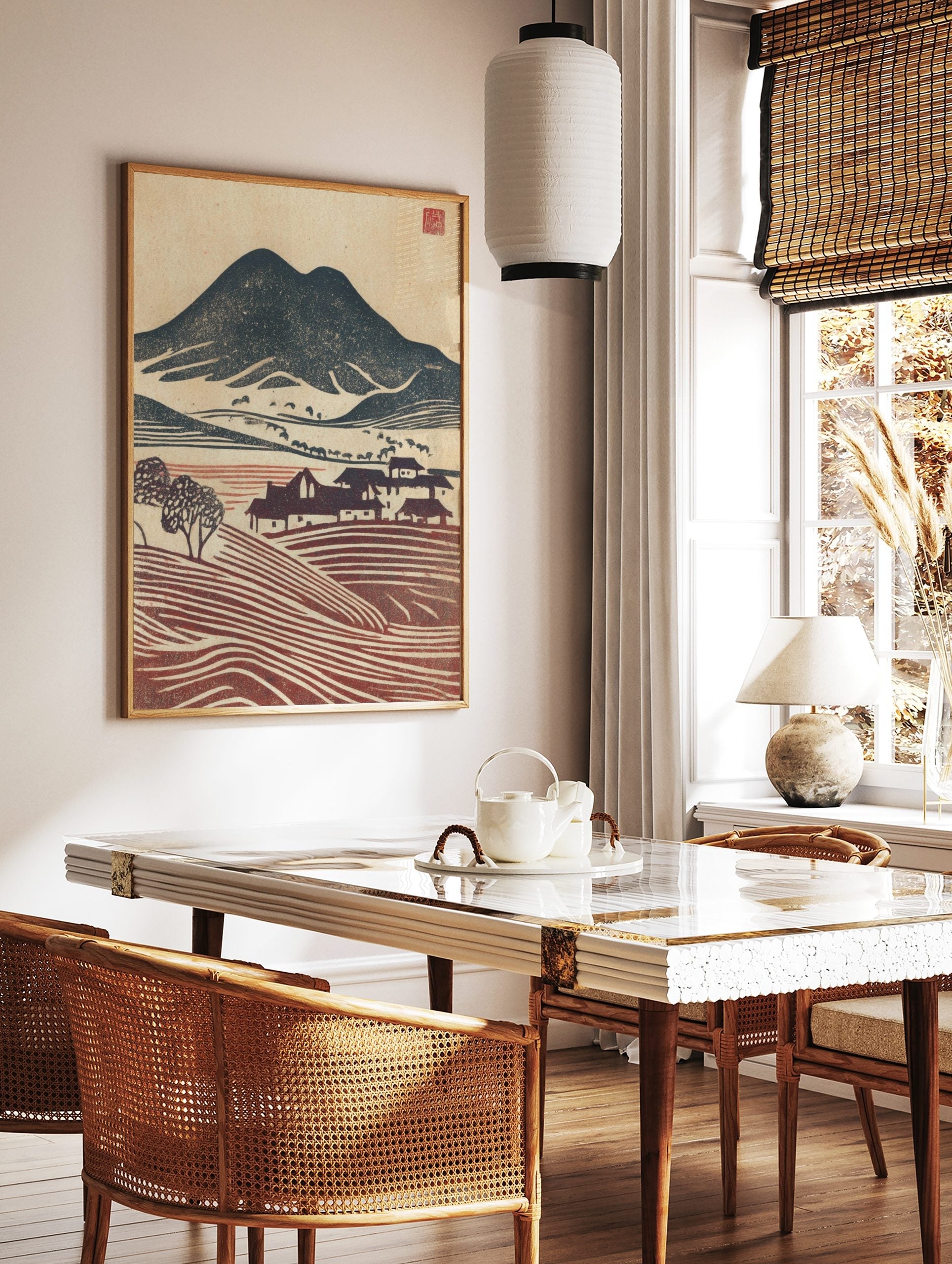Japanese woodblock style landscape print with dark mountain, village houses, and reddish-brown, in a styled room mockup