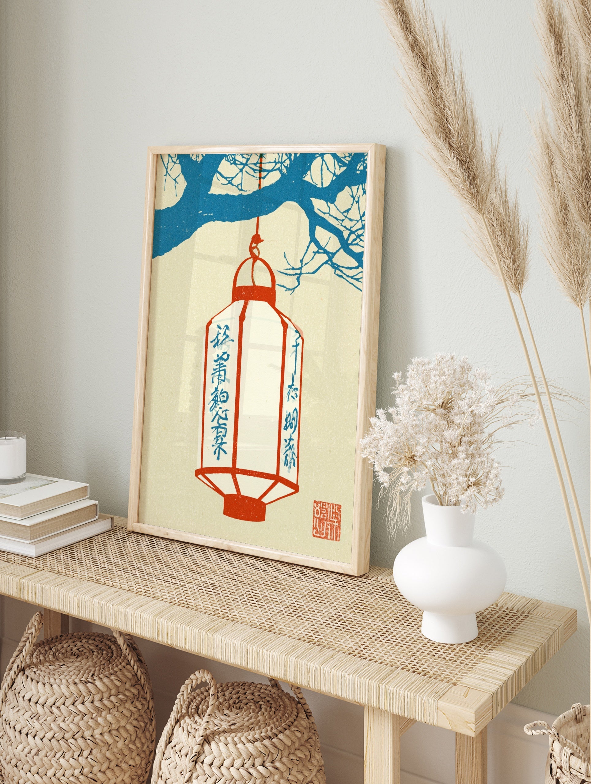 Japanese lantern wall art with a red lantern hanging from blue tree branches on a cream, in an alternate framed mockup