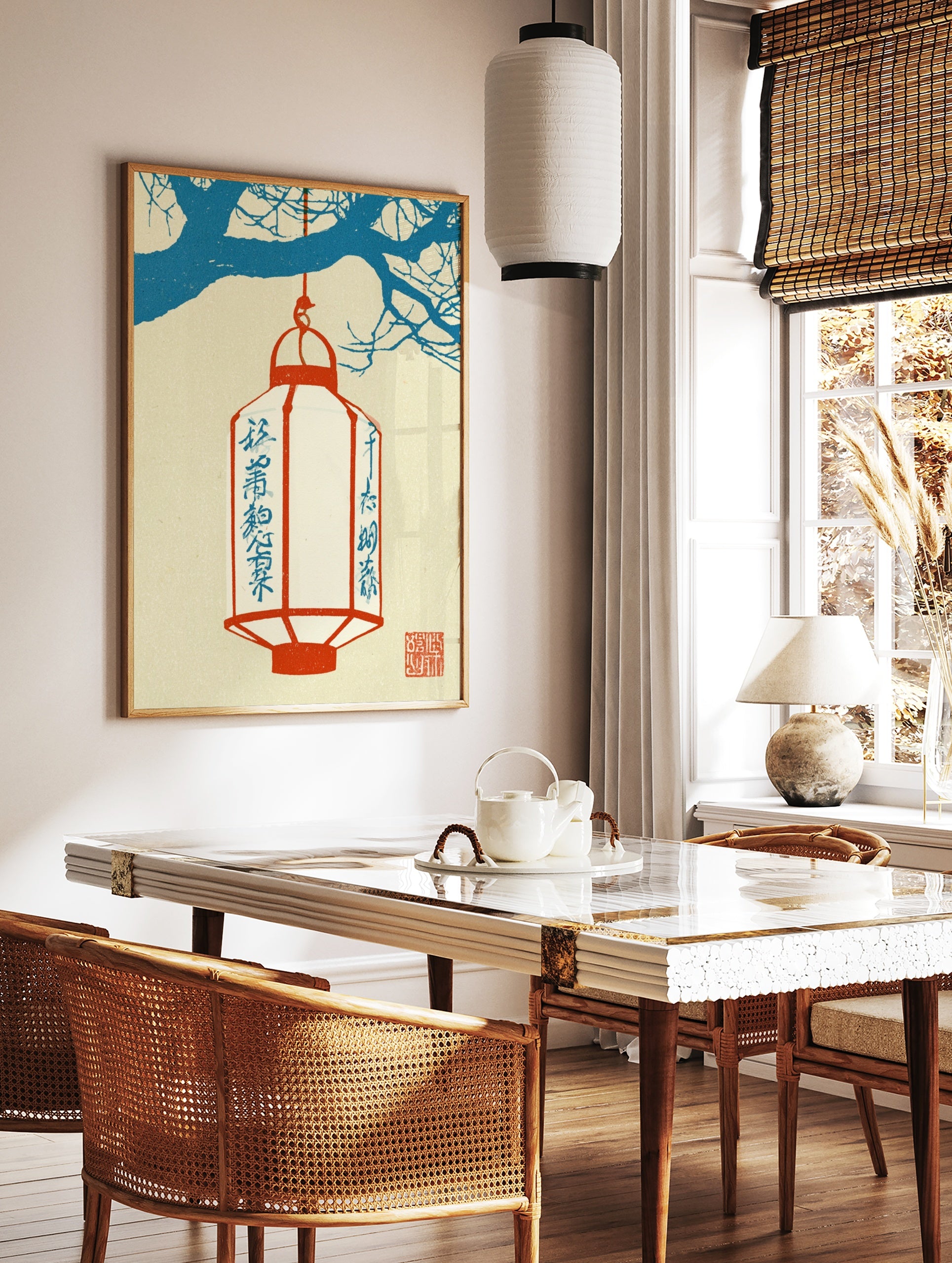 Japanese lantern wall art with a red lantern hanging from blue tree branches on a cream background, in a styled room mockup