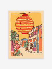 Illustrative print of a Japanese street scene with a large orange striped lantern hanging above colorful buildings and trees.