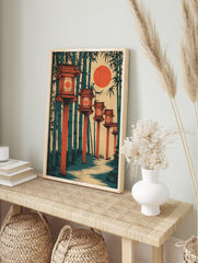 Illustrative print of Japanese lanterns along a path in a bamboo forest with a large red sun, in an alternate framed mockup