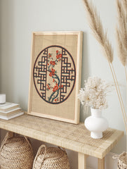 Japanese-inspired circular print featuring a red flowering branch inside a blue geometric, in an alternate framed mockup