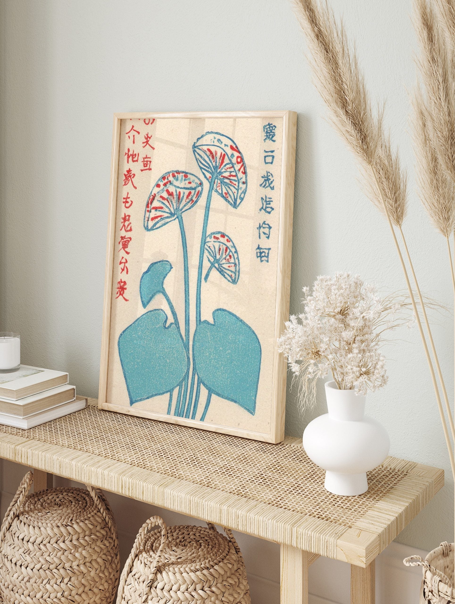 Japanese woodblock print of blue lotus flowers with red patterns and leaves, with Kanji text, in an alternate framed mockup