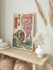 Japanese macaque woodblock print with red-faced monkey, industrial smokestacks, swirling red, in an alternate framed mockup