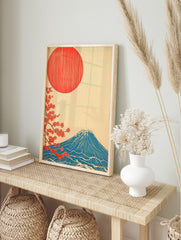 Japanese Mount Fuji art print with red sun, blue mountain, and red cherry blossoms on a cream, in an alternate framed mockup