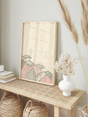 Stylized Japanese mountain landscape print with blue, red, black foliage against a beige wood, in an alternate framed mockup
