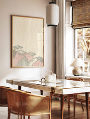 Stylized Japanese mountain landscape print with blue, red, black foliage against a beige wood grain, in a styled room mockup