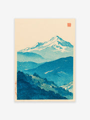 Traditional Japanese woodblock print of blue snow-capped mountains and forested hills against a cream sky.