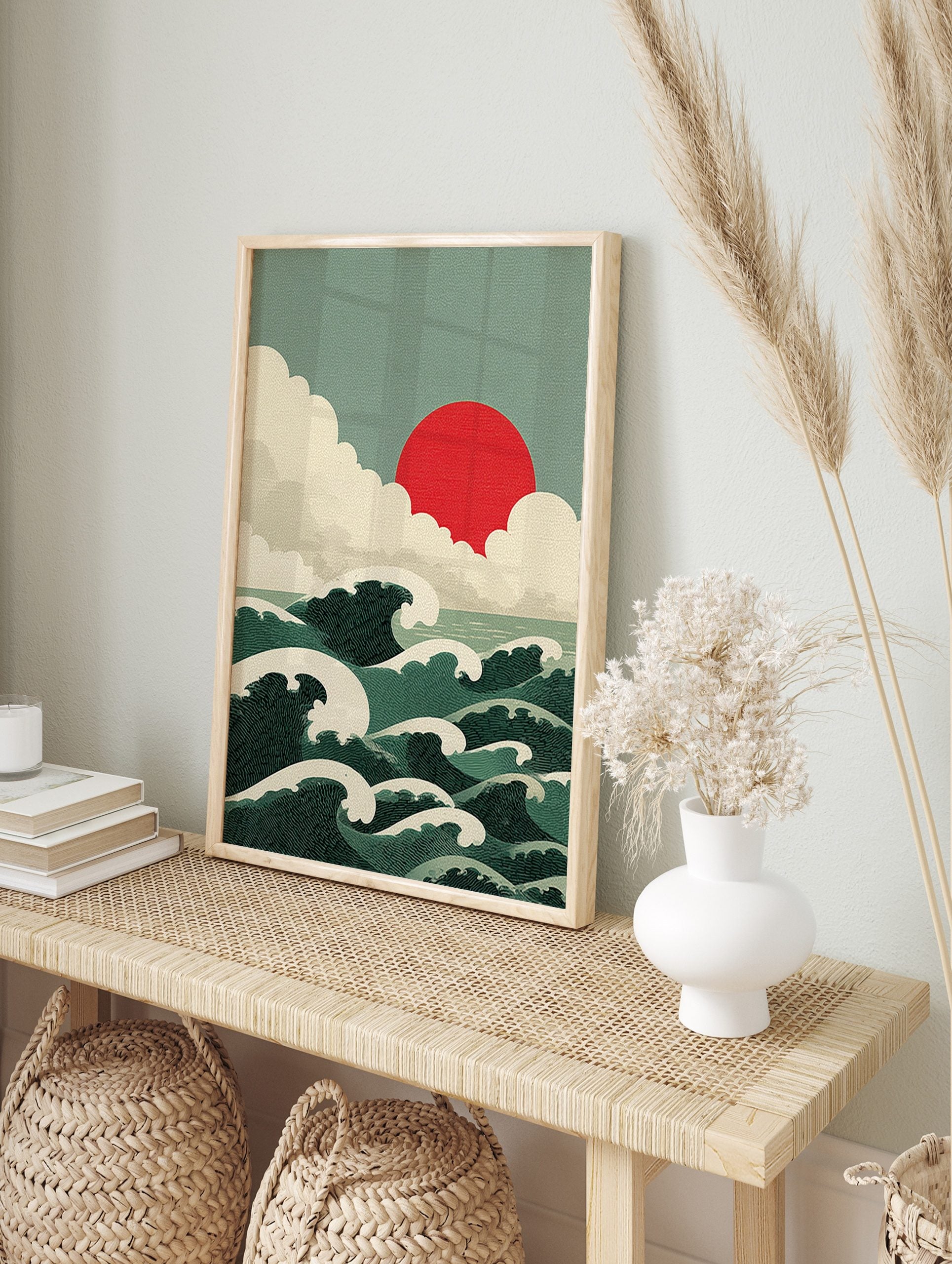 Japanese-style ocean waves with white crests, a red sun, and layered clouds in a green and, in an alternate framed mockup