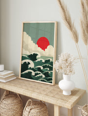 Japanese-style ocean waves with white crests, a red sun, and layered clouds in a green and, in an alternate framed mockup