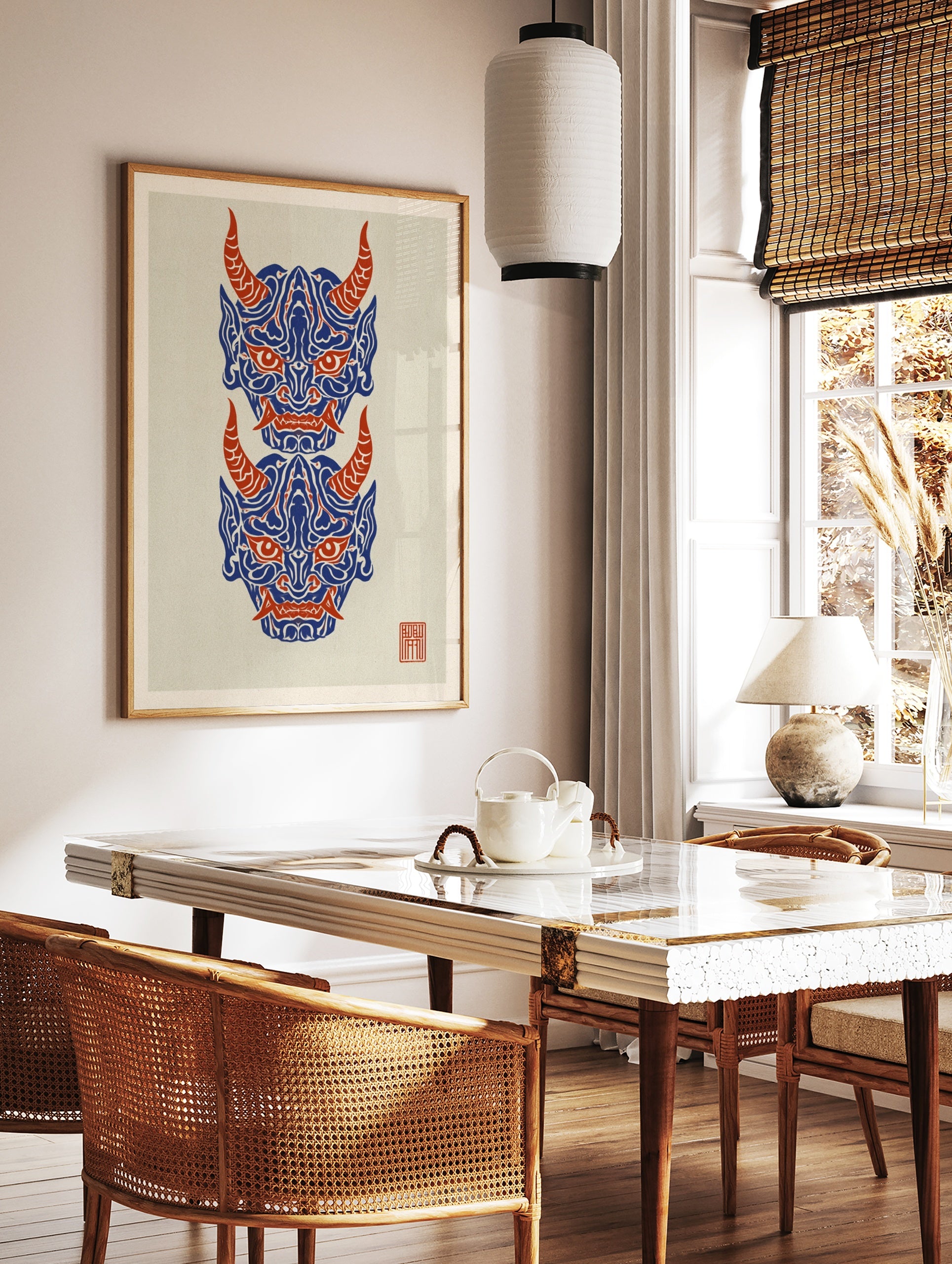 Japanese Oni mask wall art print with two stacked demon faces in blue and red on a cream background, in a styled room mockup