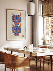 Japanese Oni mask wall art print with two stacked demon faces in blue and red on a cream background, in a styled room mockup