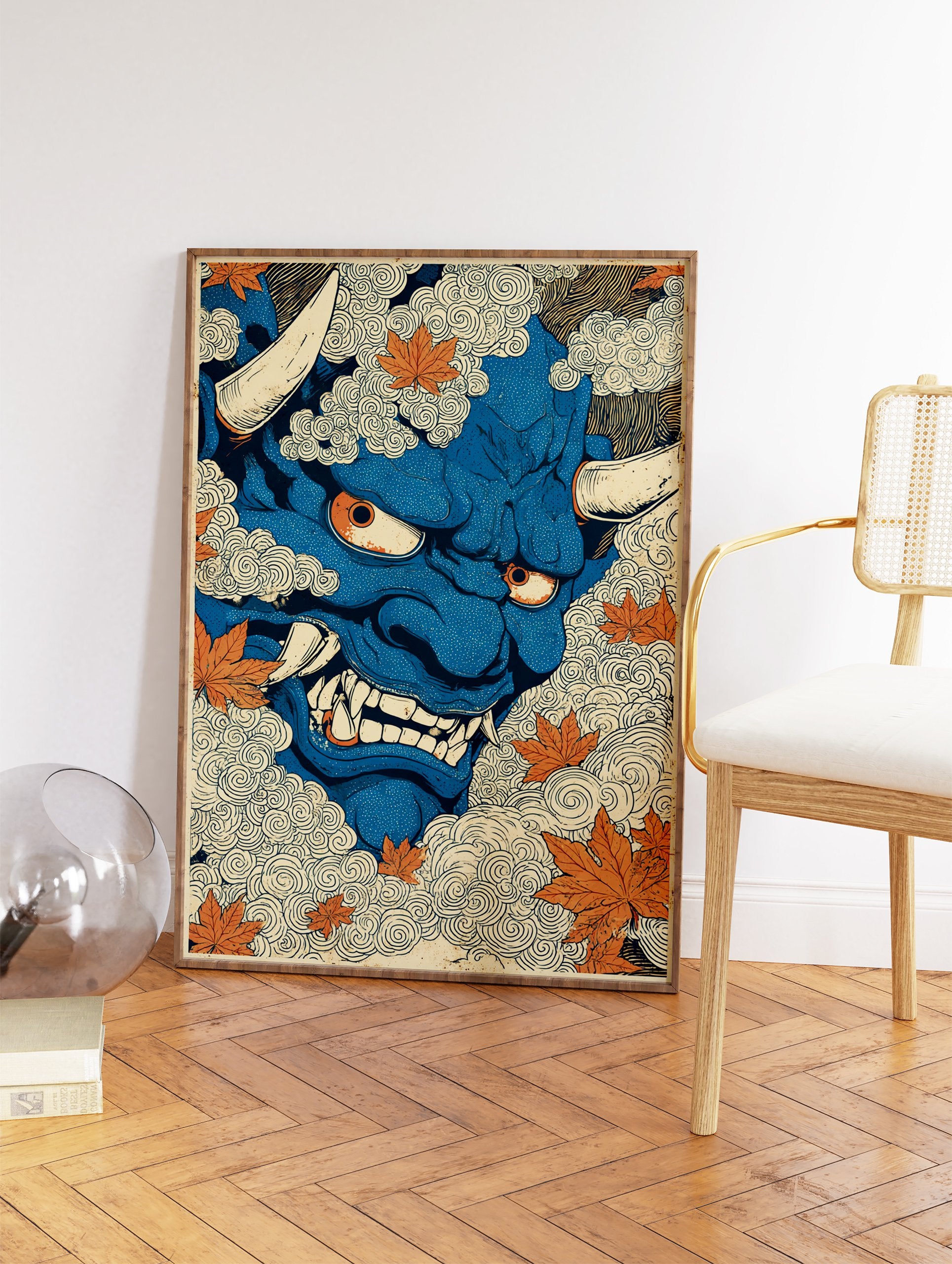 Blue Japanese Oni mask illustration with horns and fangs, surrounded by swirling clouds and orange maple leaves. - Image 2