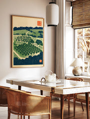 Japanese woodblock-style orchard landscape print with trees, terraced fields, and traditional red, in a styled room mockup
