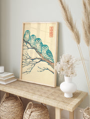 Japanese owl art print of four teal and white owls perched on a brown, snow-covered branch against a cream background. - Image 3