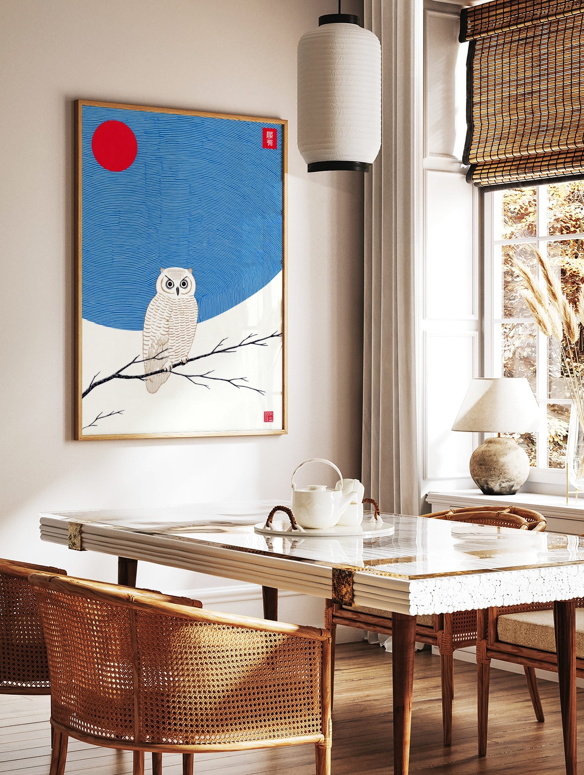 White owl with golden details perched on a branch, red sun and wavy blue sky in Japanese, in a styled room mockup