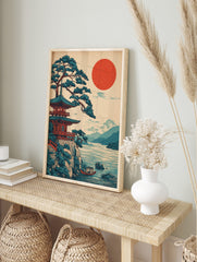Japanese pagoda temple and pine tree on a cliff overlooking a lake with a red sun and, in an alternate framed mockup