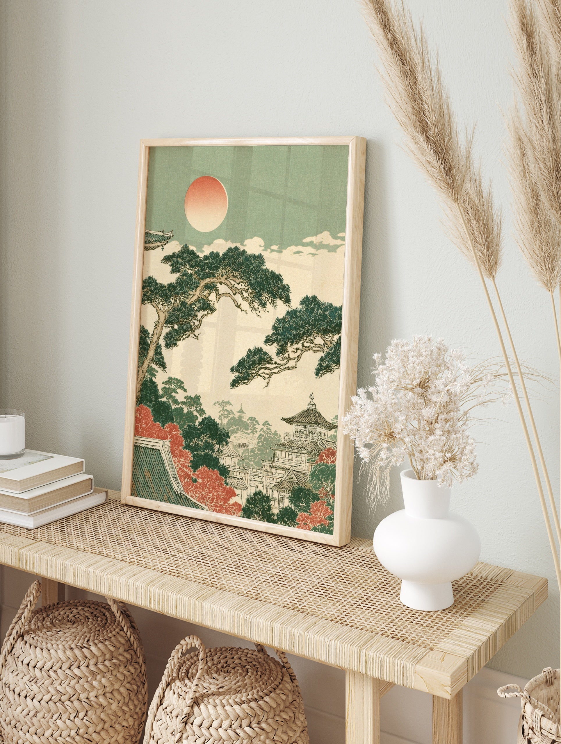Japanese pagoda landscape print with pine trees, autumn foliage, and a soft sun in an, in an alternate framed mockup