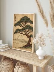 Japanese woodblock print of a pine tree with green foliage, Mount Fuji, and calligraphy on a, in an alternate framed mockup