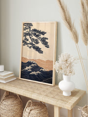Japanese illustrative wall art with navy pine tree branch over golden and navy ocean waves, in an alternate framed mockup