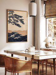 Japanese illustrative wall art with navy pine tree branch over golden and navy ocean waves with, in a styled room mockup