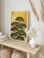 Stylised Japanese pine trees with fan-shaped green foliage and dark trunks against a gold and, in an alternate framed mockup