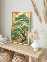 Japanese pine tree illustration with green foliage and dark branches on a textured gold leaf, in an alternate framed mockup