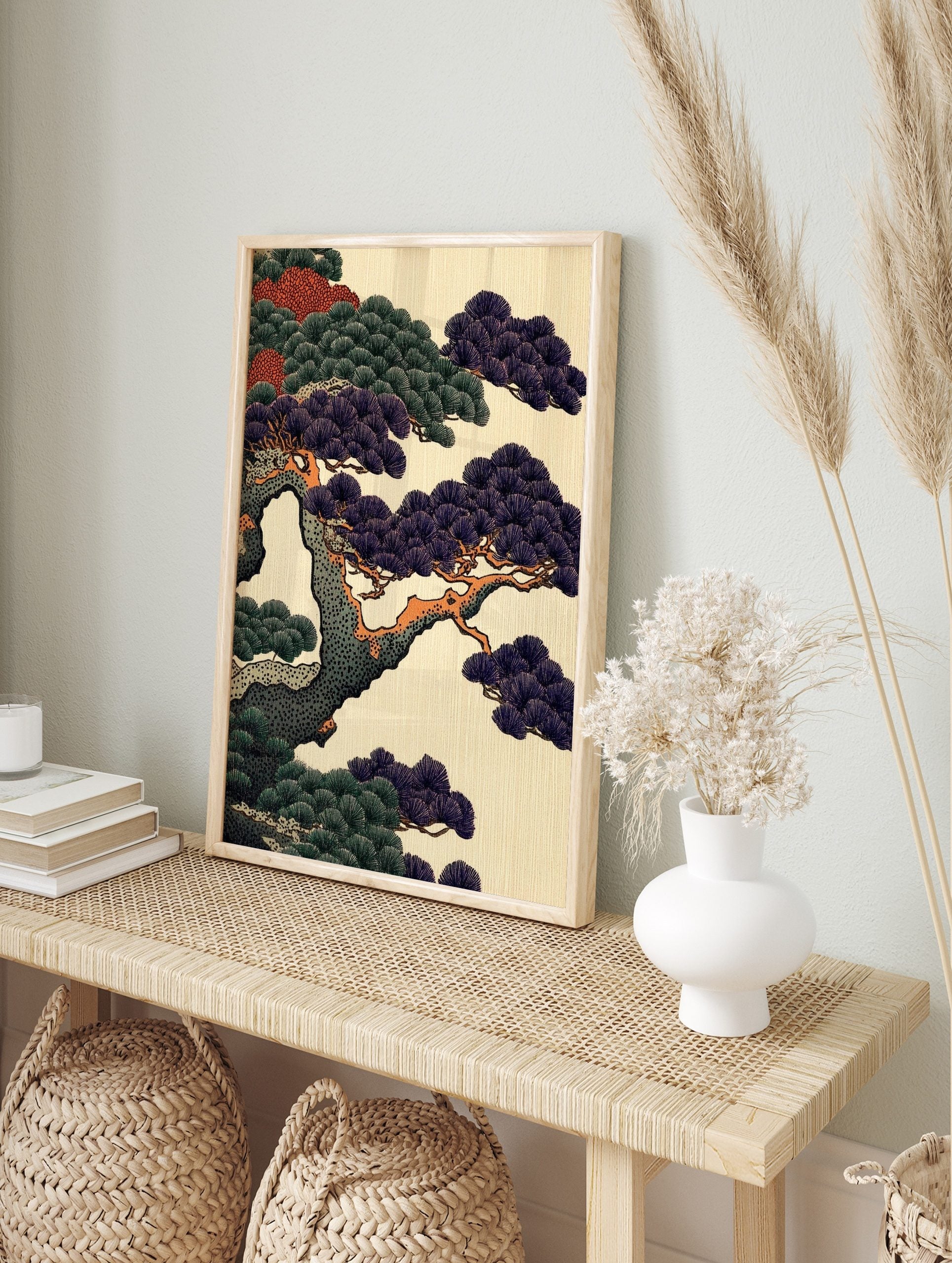 Close-up of a Japanese pine tree with dark purple and green needles on orange-brown branches, in an alternate framed mockup