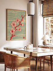 Japanese plum blossom branch with red and beige flowers on a pale teal textured background, in a styled room mockup
